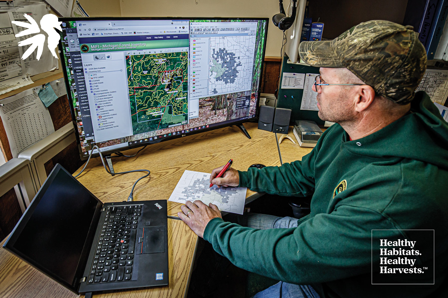 person at a computer evaluating aerial maps