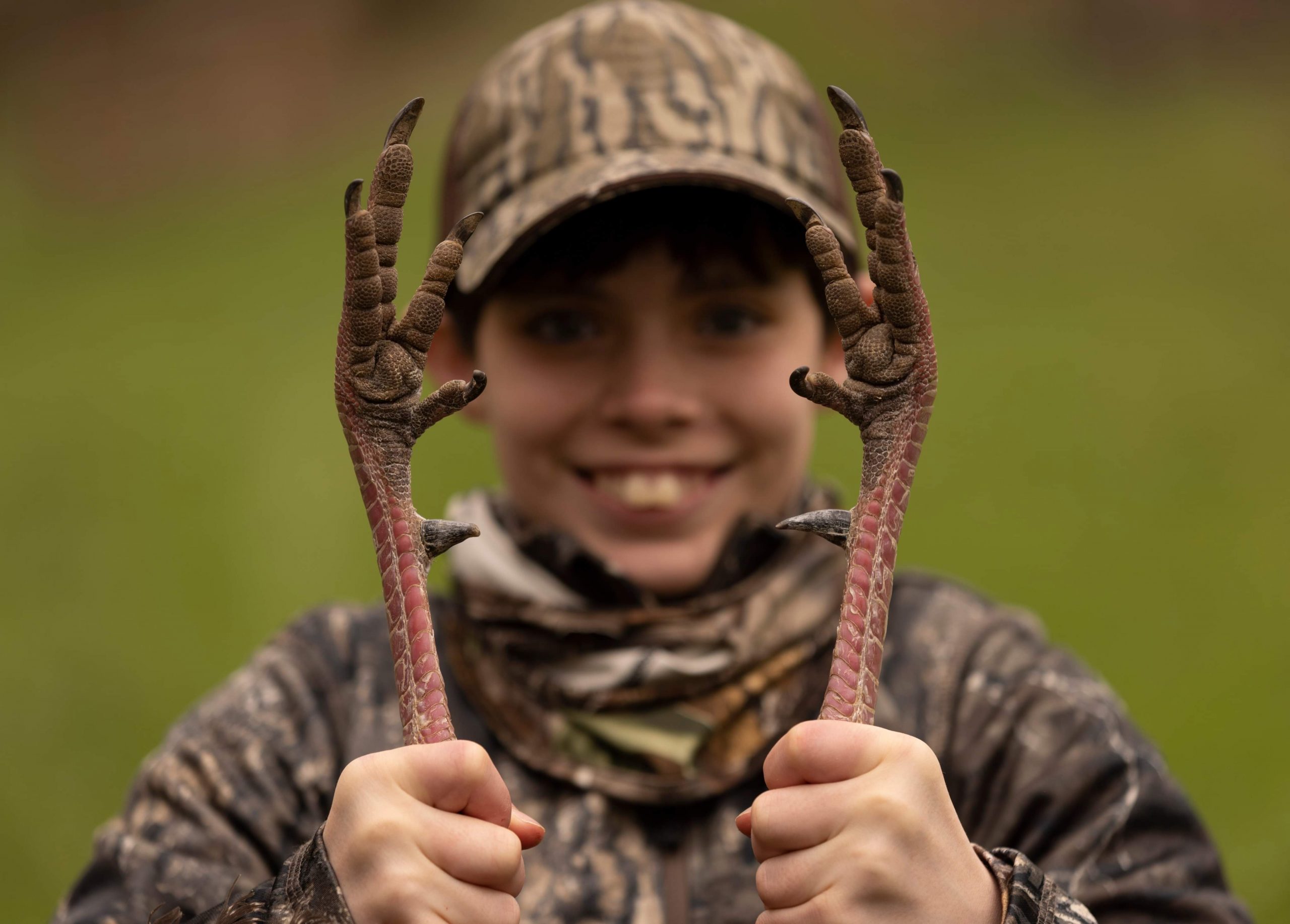 boy holding a turkey by its feet