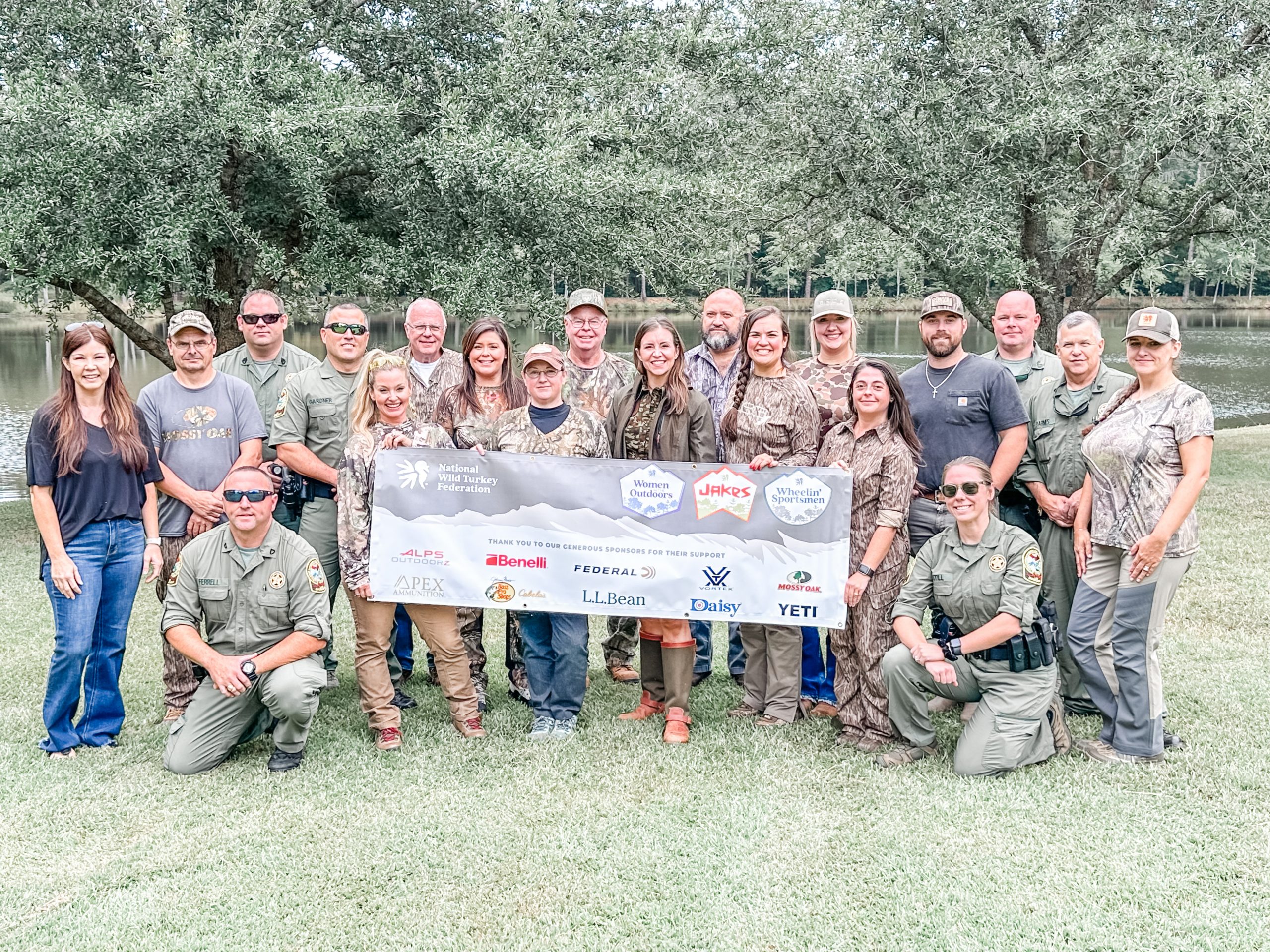 NWTF volunteers, partners, and DNR representatives pose for a photo.