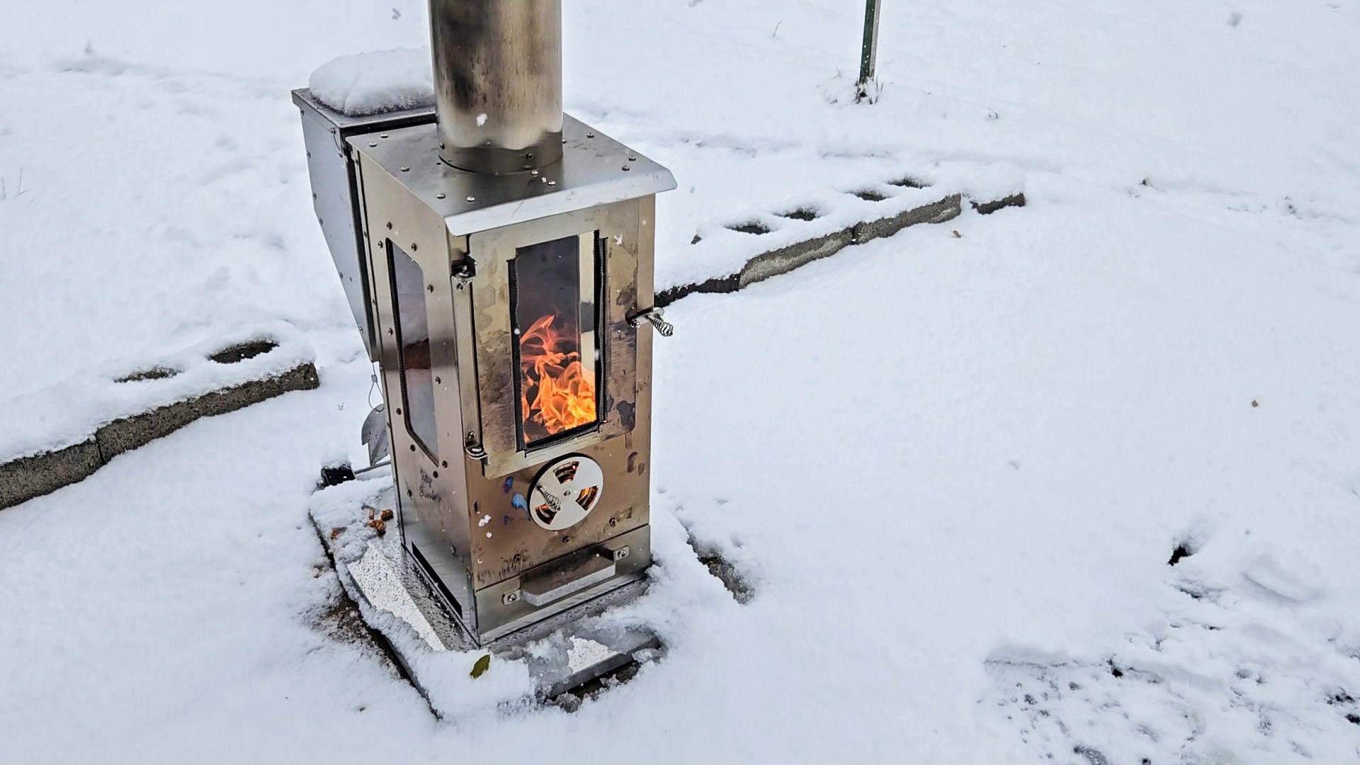 Timber Stove burns in the snow