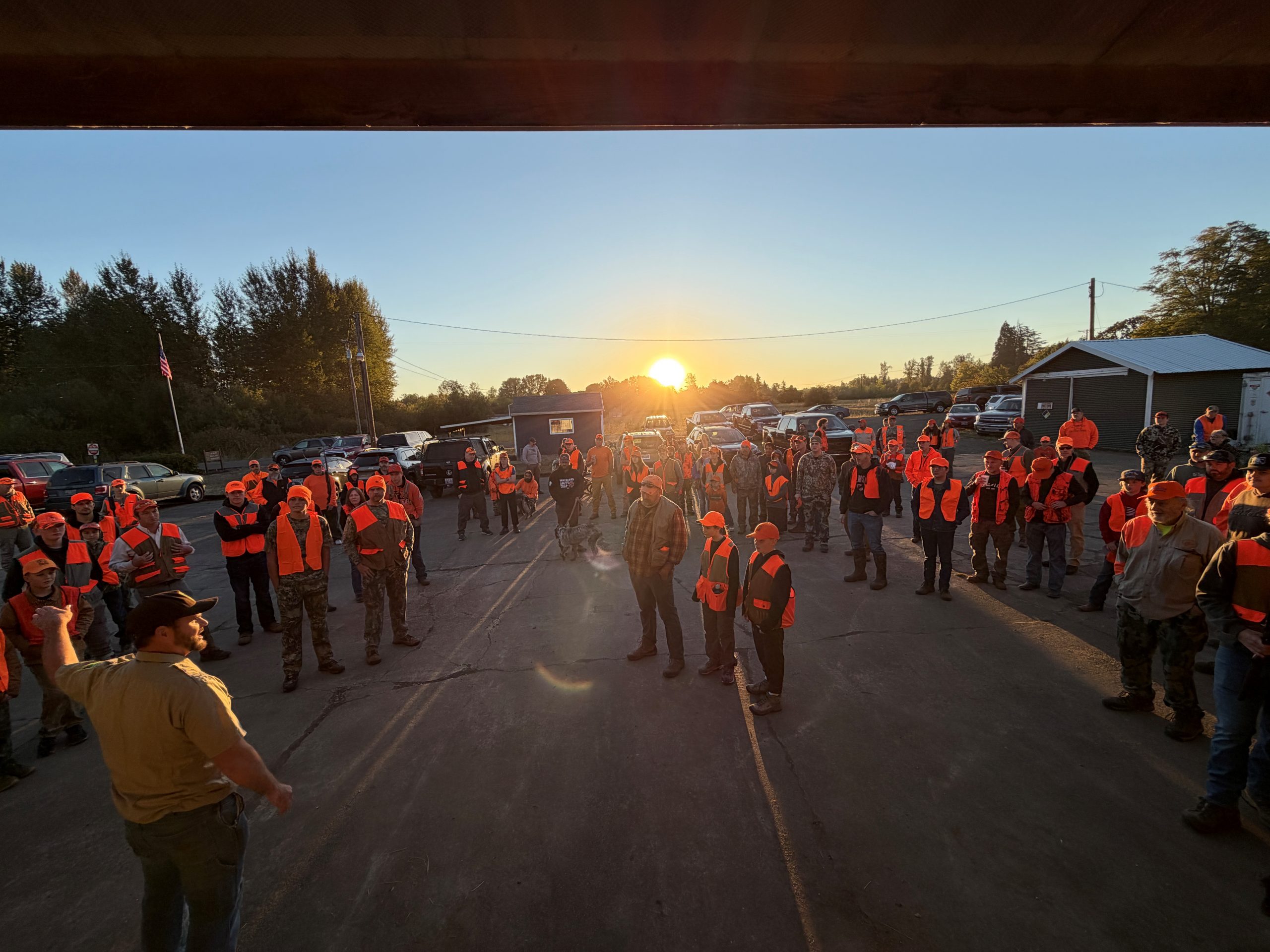 Group of youth hunters stand listening to the morning safety meeting before the hunt